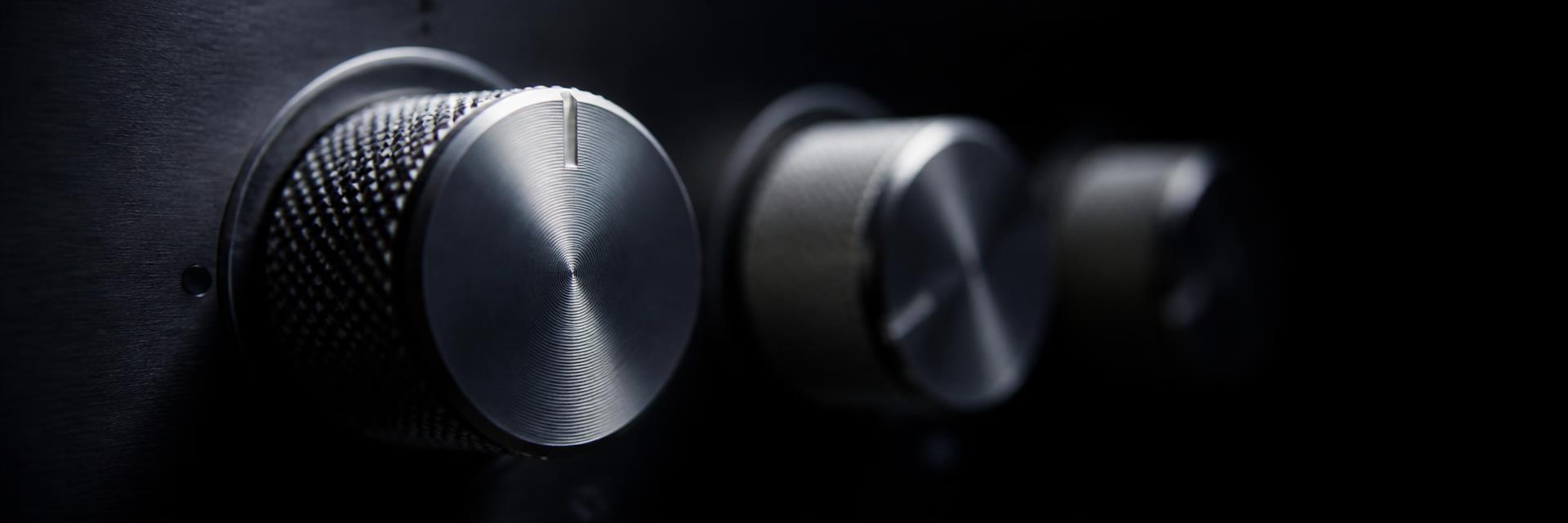 Macro detail of the rotary controls on an analogue mastering processor